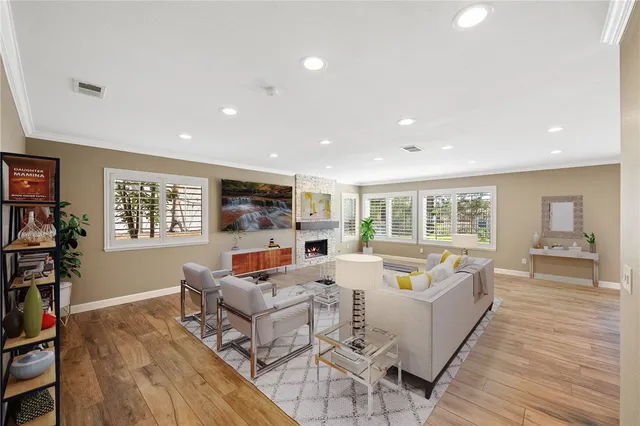 a living room with fireplace furniture and a flat screen tv