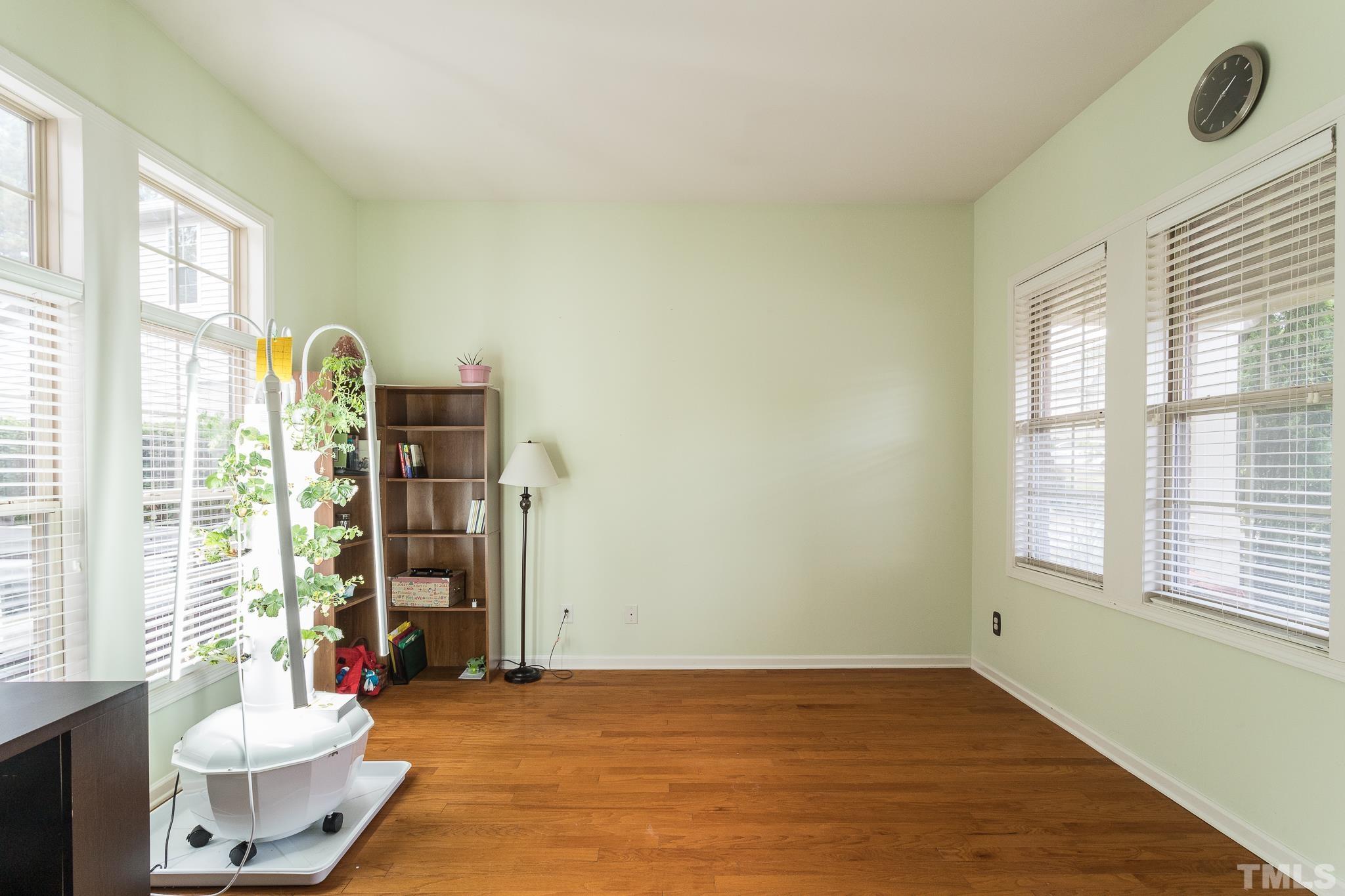 6221 Oconner Street Raleigh, NC 27617 - Photo 11 of 26 a view of an empty room with a window and wooden floor