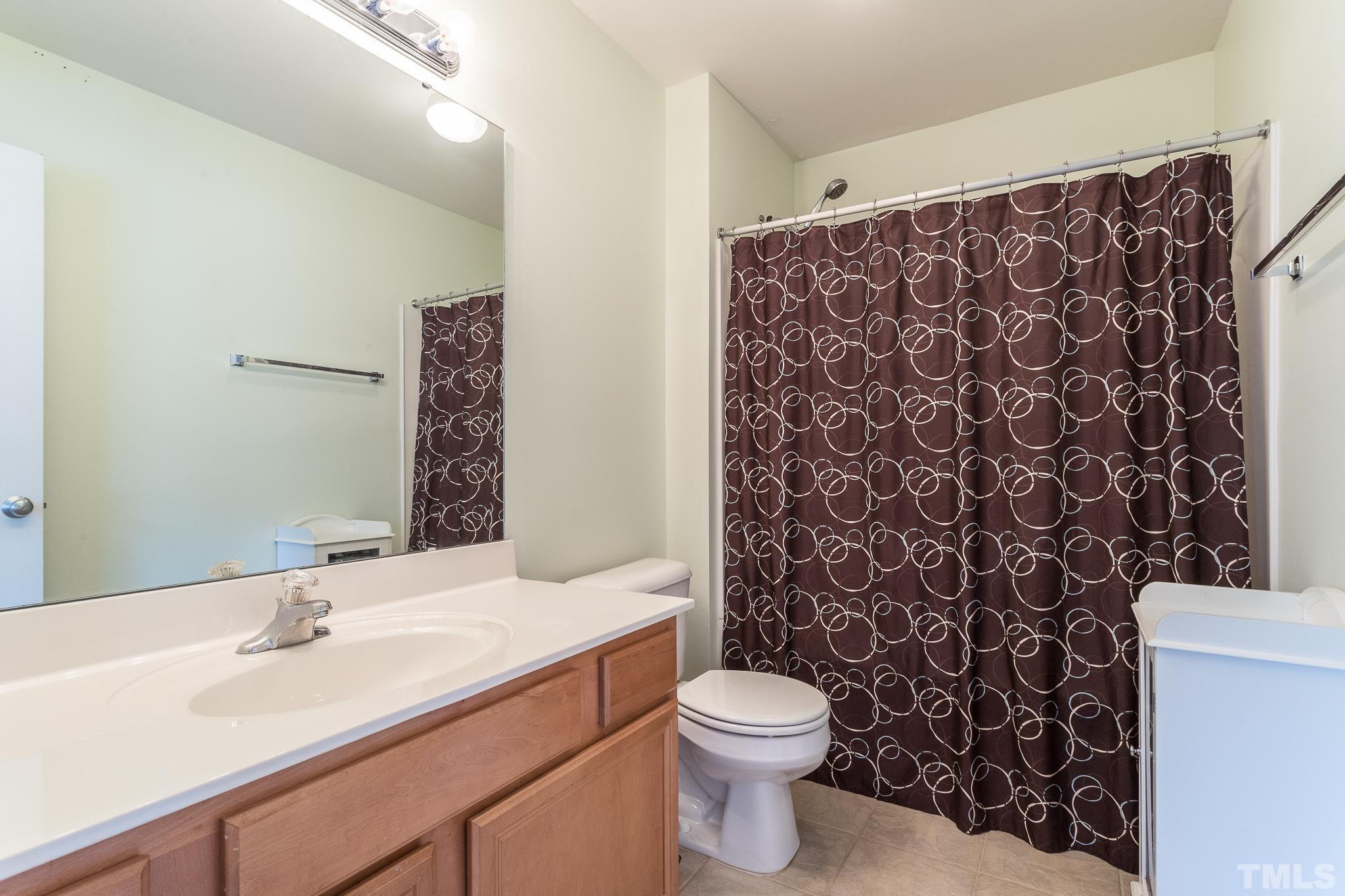 6221 Oconner Street Raleigh, NC 27617 - Photo 17 of 26 a bathroom with a sink toilet and shower