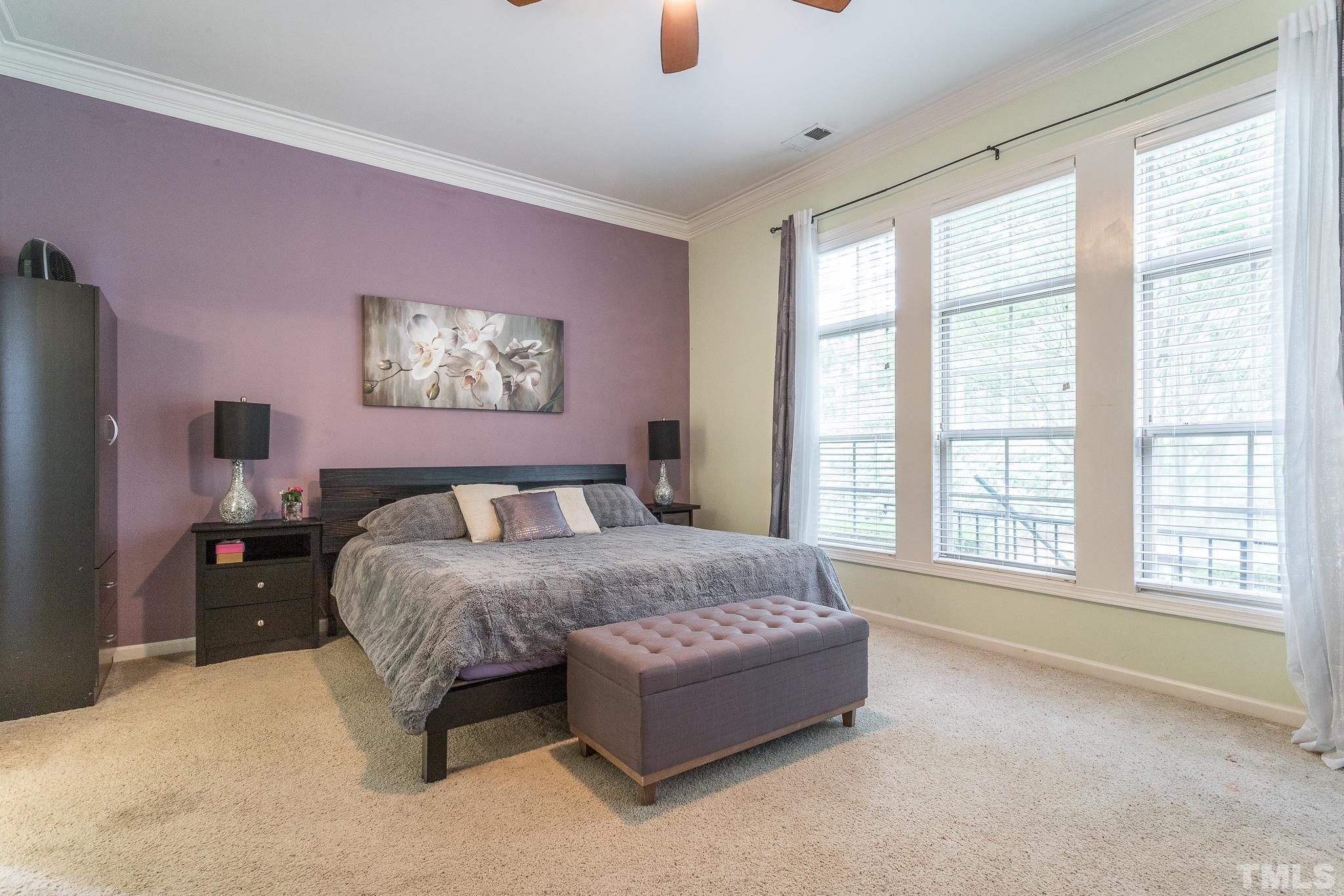 6221 Oconner Street Raleigh, NC 27617 - Photo 20 of 26 a spacious bedroom with a bed and large windows