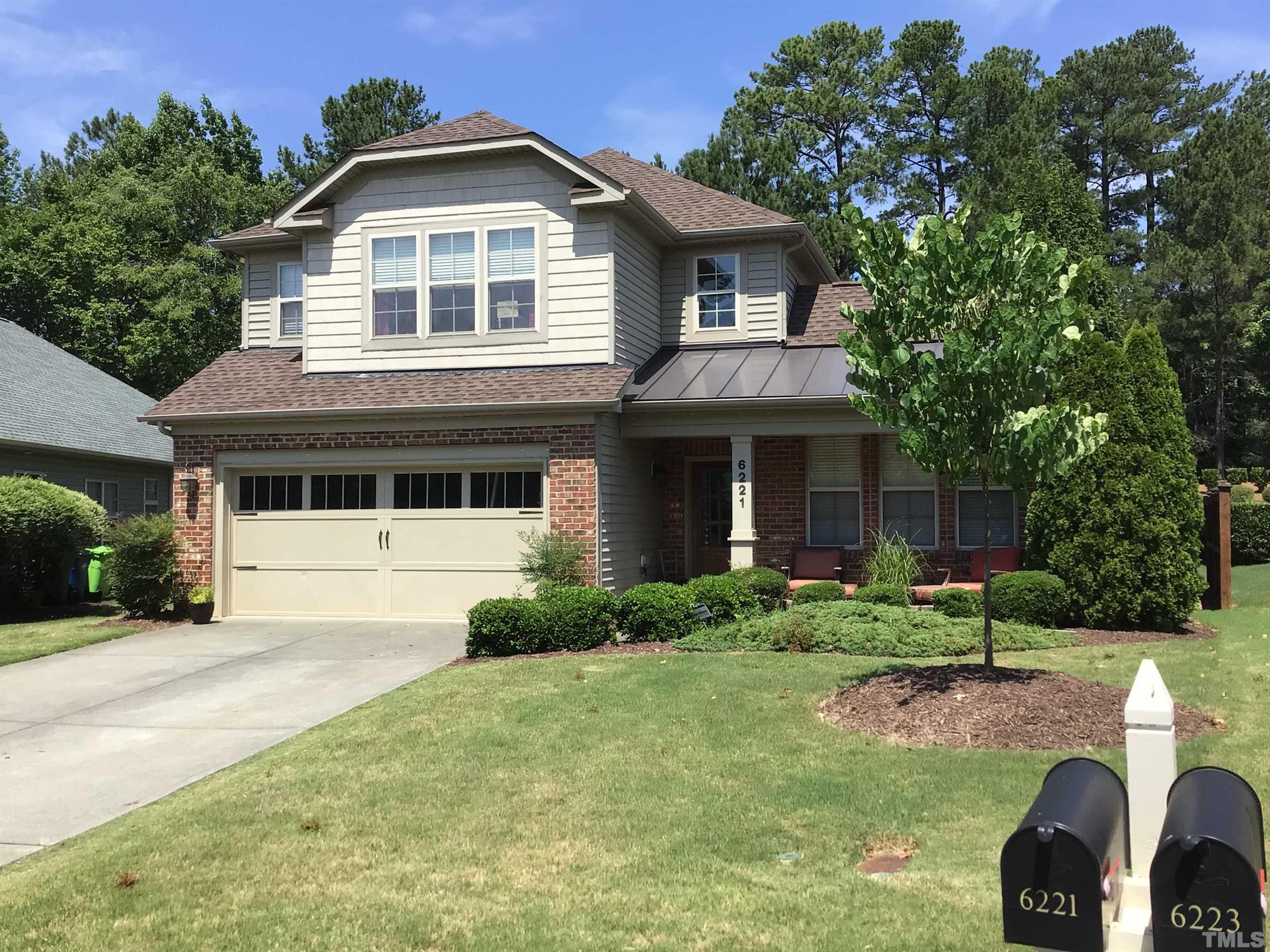 6221 Oconner Street Raleigh, NC 27617 - Photo 2 of 26 a front view of a house with a yard and porch