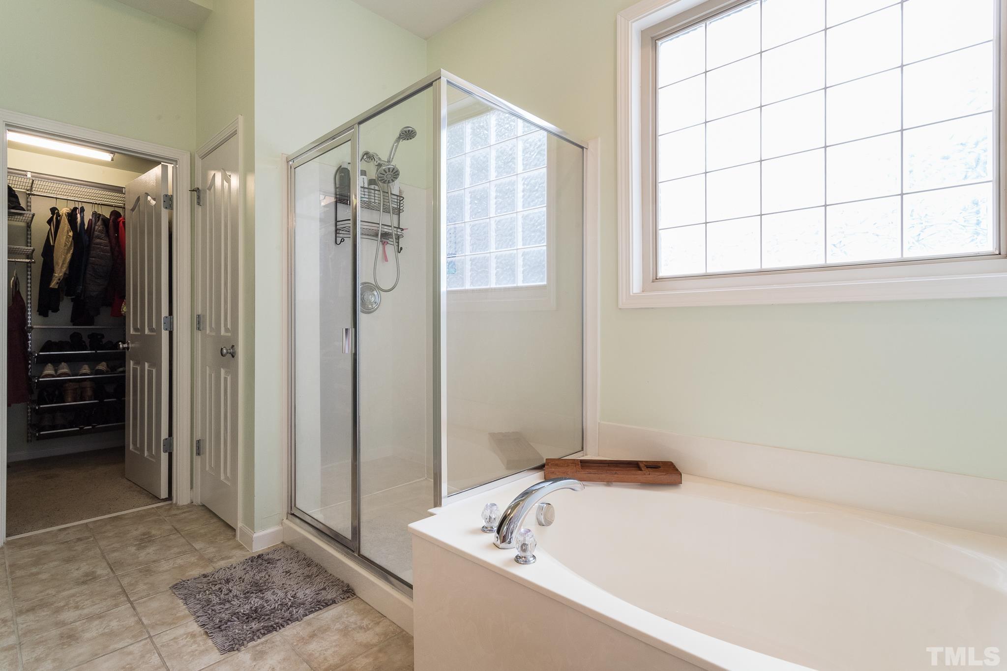 6221 Oconner Street Raleigh, NC 27617 - Photo 23 of 26 a bathroom with a bathtub and a shower