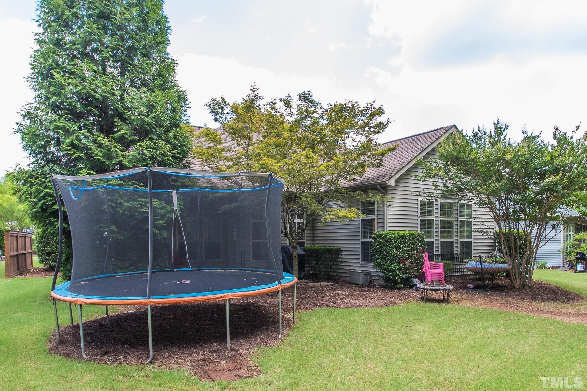 6221 Oconner Street Raleigh, NC 27617 - Photo 24 of 26 a view of a wooden chairs and a bench in the backyard
