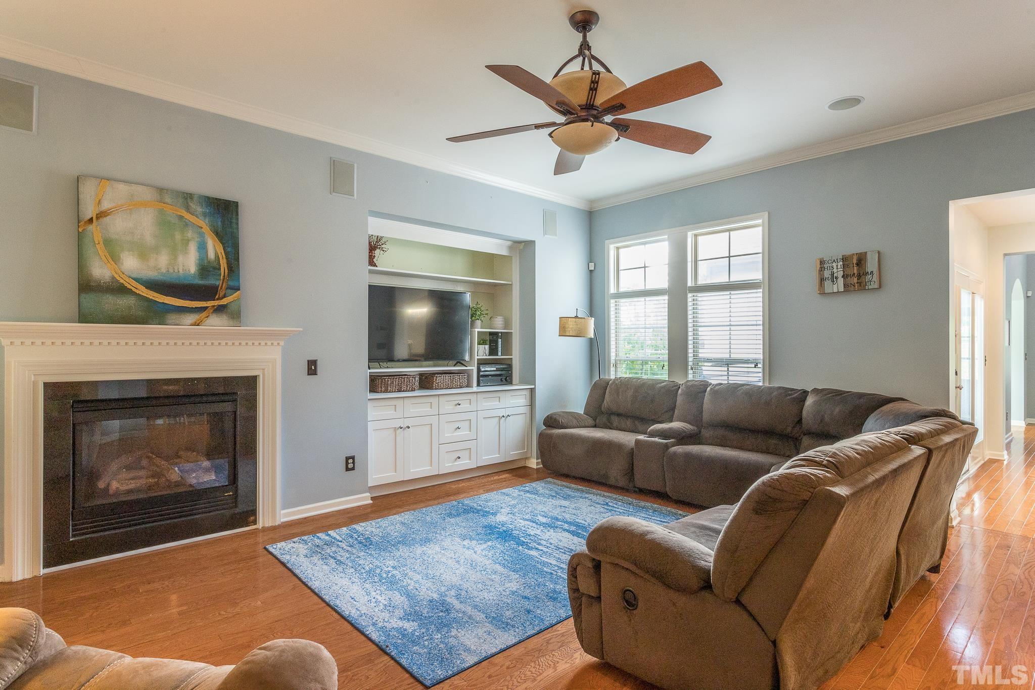 6221 Oconner Street Raleigh, NC 27617 - Photo 6 of 26 a living room with furniture a flat screen tv and a fireplace