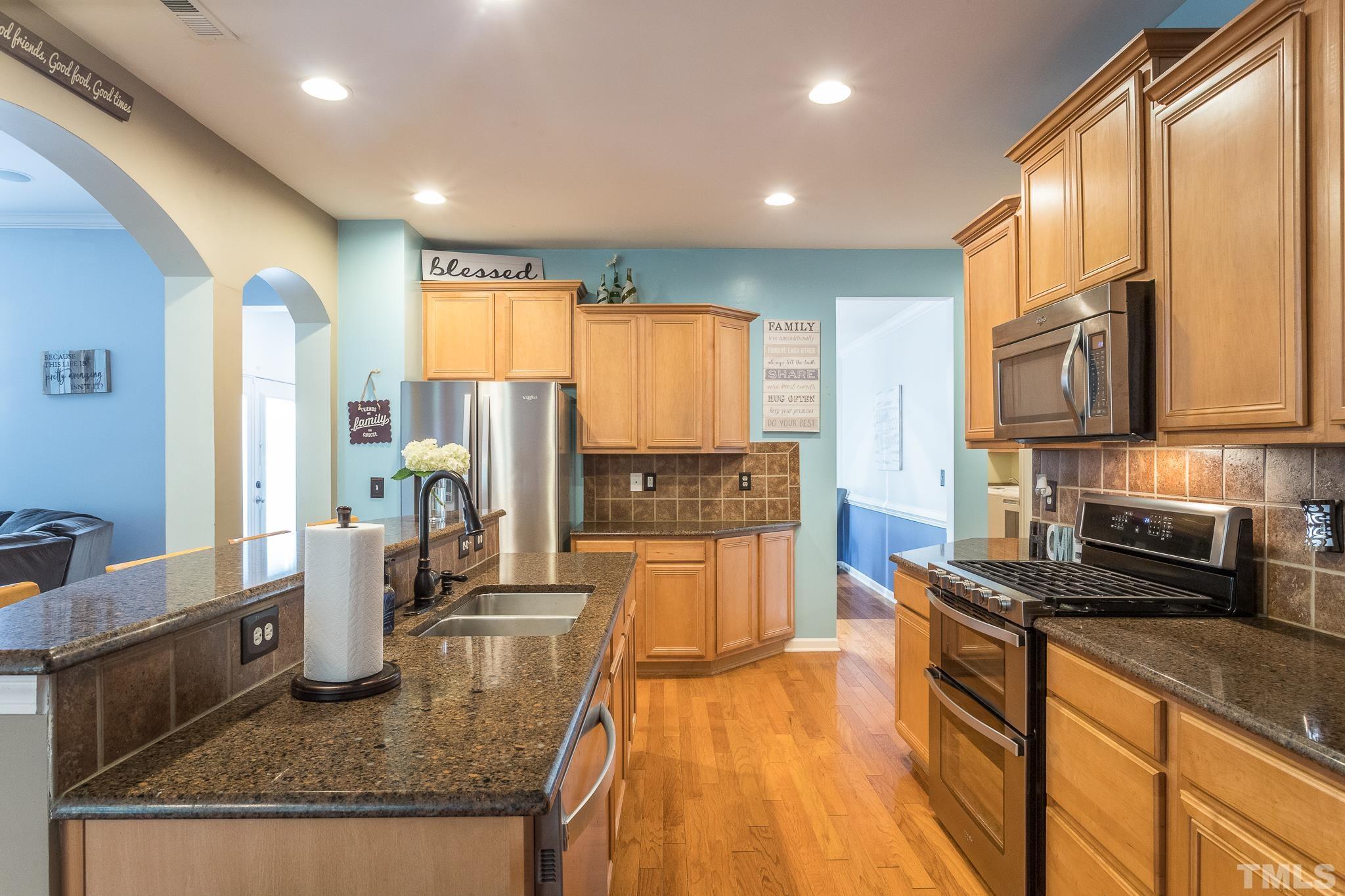 6221 Oconner Street Raleigh, NC 27617 - Photo 9 of 26 a kitchen with stainless steel appliances granite countertop sink stove refrigerator and cabinets
