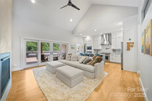 a living room with kitchen island furniture and a large window