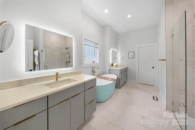 a spacious bathroom with a double vanity sink mirror and double