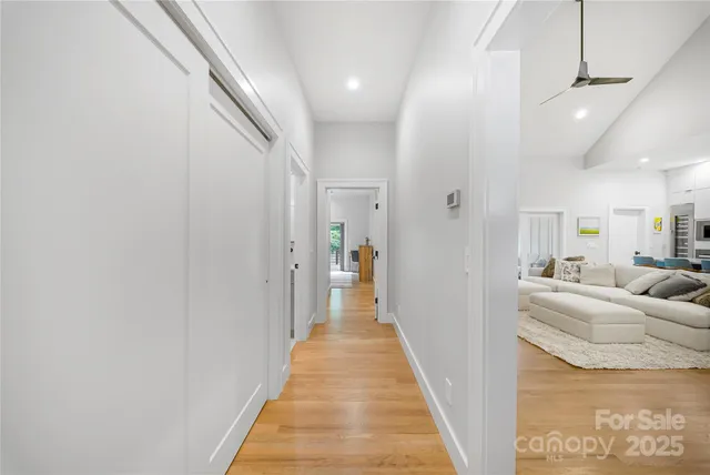 a view of a hallway with a couch and chandelier