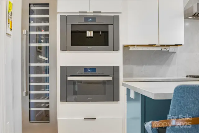 a kitchen with stainless steel appliances a stove and a microwave