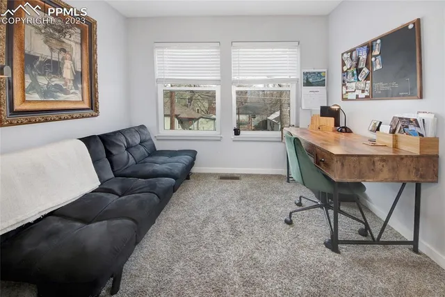a living room with furniture and a window