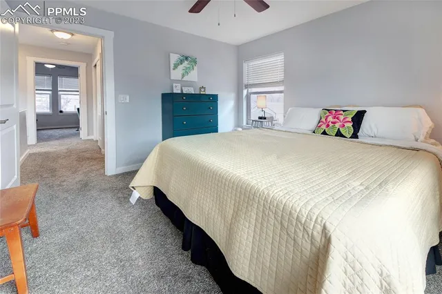 a spacious bedroom with a bed and a cabinets