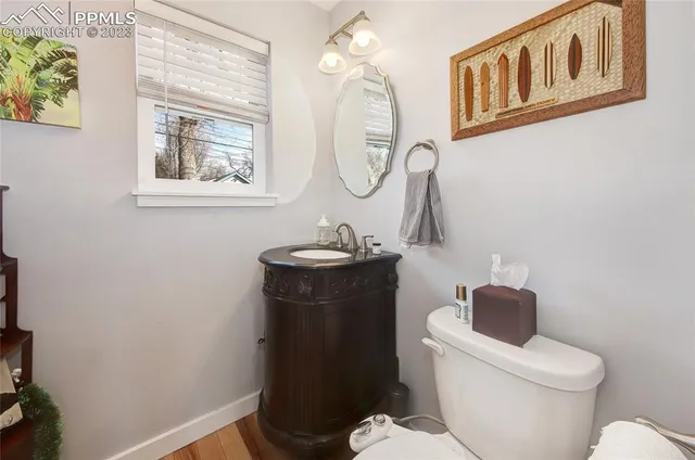 a bathroom with a toilet a sink and mirror