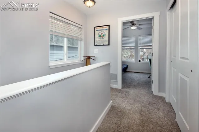 a view of hallway with window and bathroom