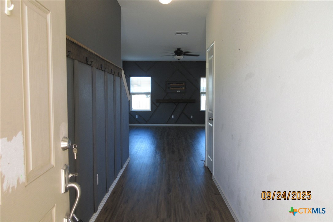 125 Greatest Gift Way Jarrell, TX 76537 - Photo 2 of 24 a view of a hallway with wooden floor