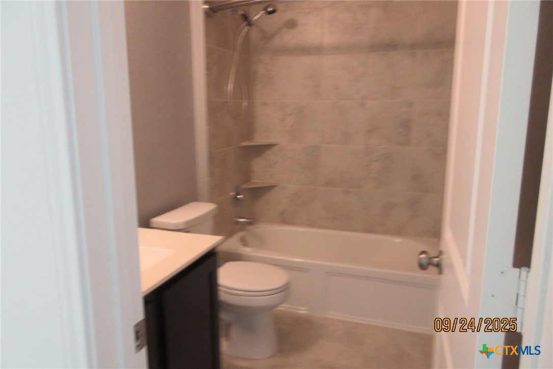 125 Greatest Gift Way Jarrell, TX 76537 - Photo 22 of 24 a bathroom with a granite countertop bathtub shower sink vanity and toilet