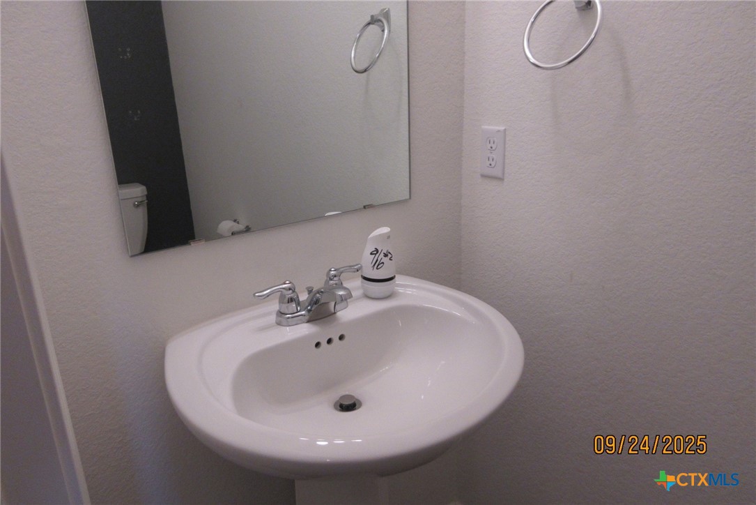 125 Greatest Gift Way Jarrell, TX 76537 - Photo 3 of 24 a bathroom with a sink and mirror