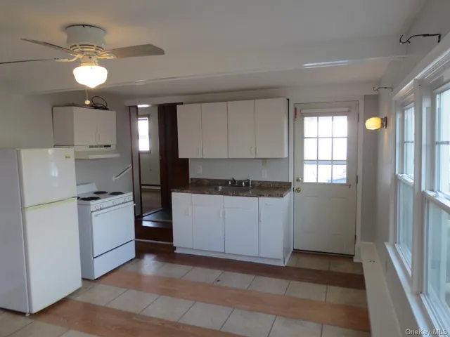 a kitchen with a refrigerator and a stove