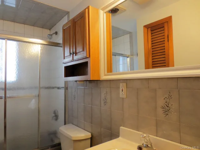 a bathroom with a toilet a sink and shower