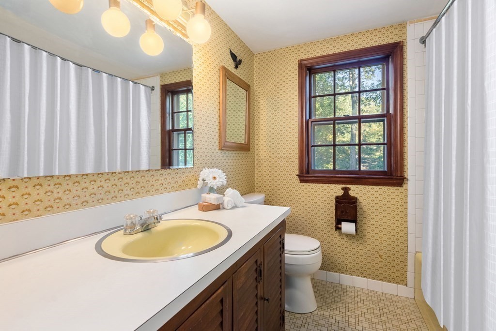 406 Chestnut Street Ashland, MA 01721 - Photo 12 of 28 a bathroom with a sink a toilet and a mirror