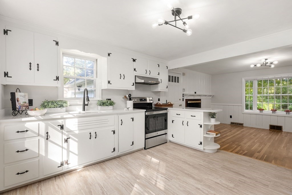 406 Chestnut Street Ashland, MA 01721 - Photo 14 of 28 a kitchen with white cabinets and white appliances