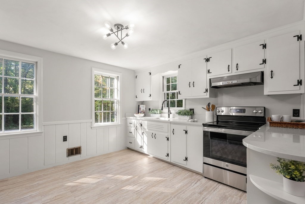 406 Chestnut Street Ashland, MA 01721 - Photo 16 of 28 a kitchen with cabinets wooden floor and a window