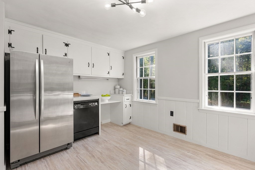 406 Chestnut Street Ashland, MA 01721 - Photo 18 of 28 a kitchen with stainless steel appliances granite countertop a refrigerator a sink a stove and white cabinets with wooden floor