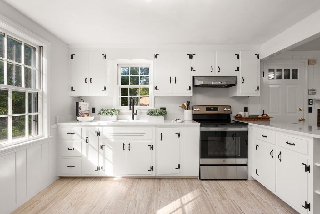 406 Chestnut Street Ashland, MA 01721 - Photo 3 of 28 a kitchen with stainless steel appliances granite countertop a stove a sink and white cabinets