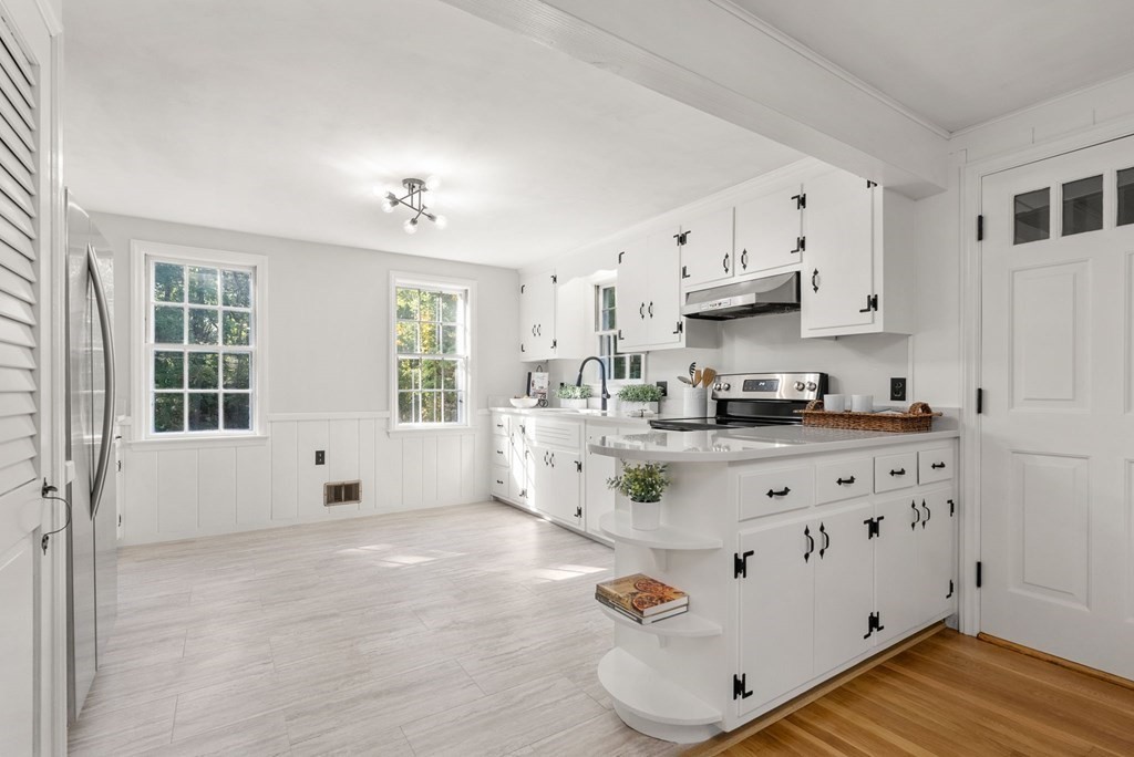 406 Chestnut Street Ashland, MA 01721 - Photo 8 of 28 a kitchen with stainless steel appliances granite countertop a stove and white cabinets