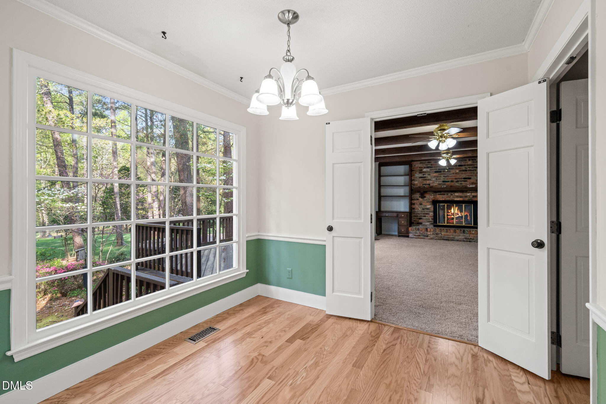 6115 Winthrop Drive Raleigh, NC 27612 - Photo 12 of 41 a view of an empty room with a window and wooden floor