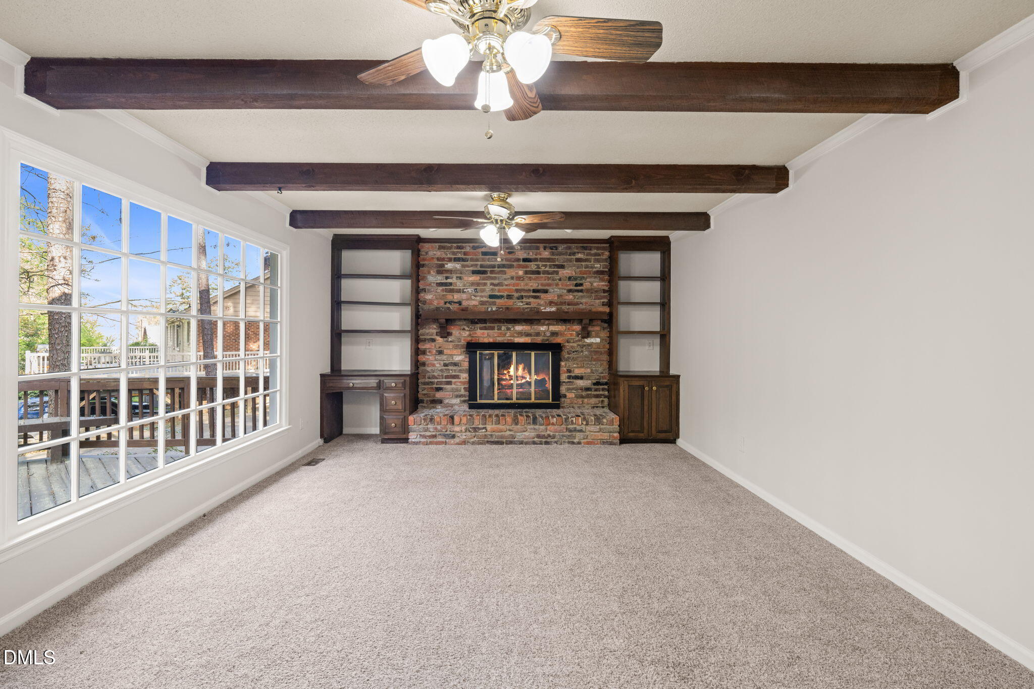 6115 Winthrop Drive Raleigh, NC 27612 - Photo 14 of 41 a view of an empty room with a fireplace and a window