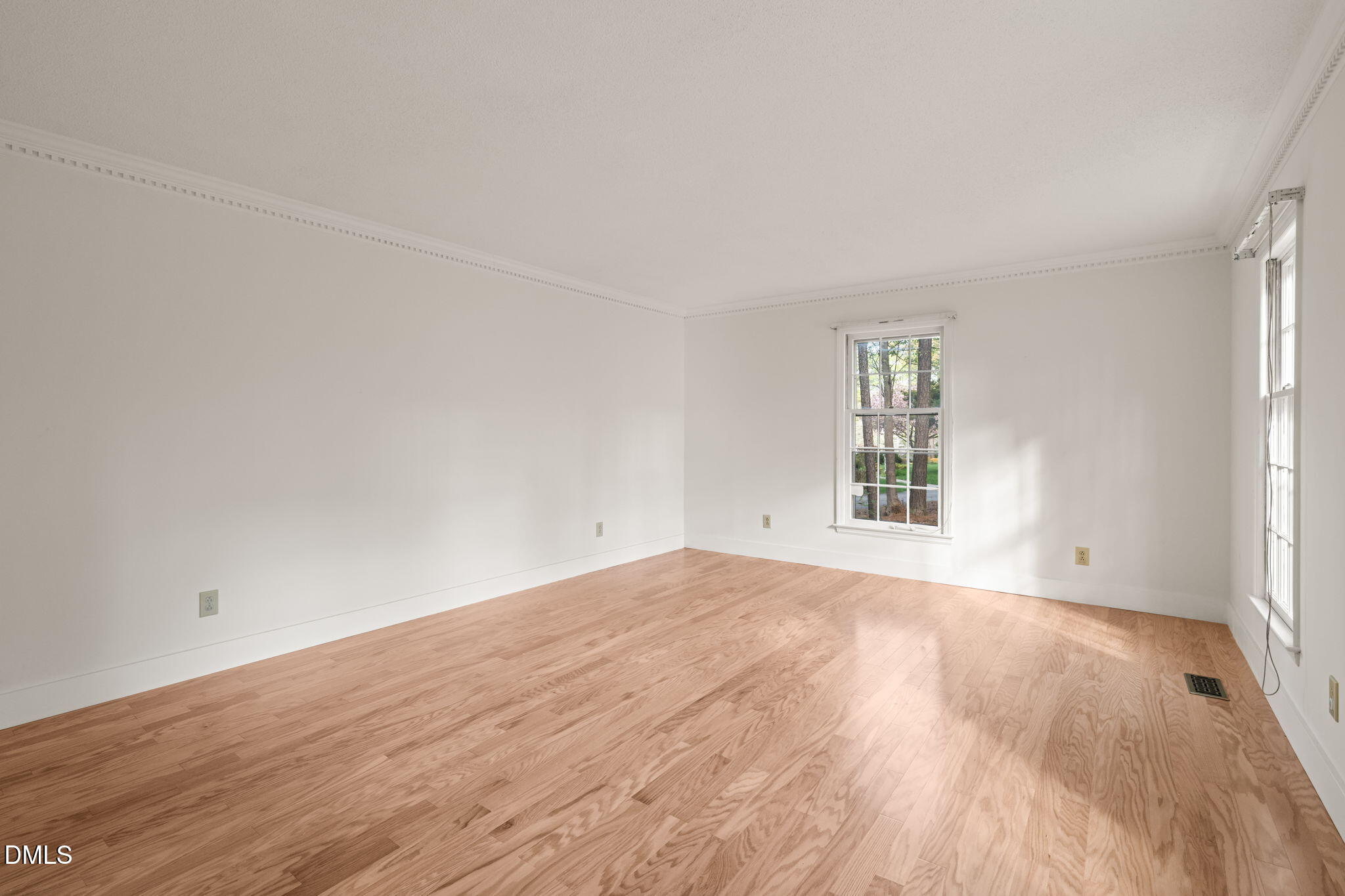6115 Winthrop Drive Raleigh, NC 27612 - Photo 17 of 41 an empty room with wooden floor and windows