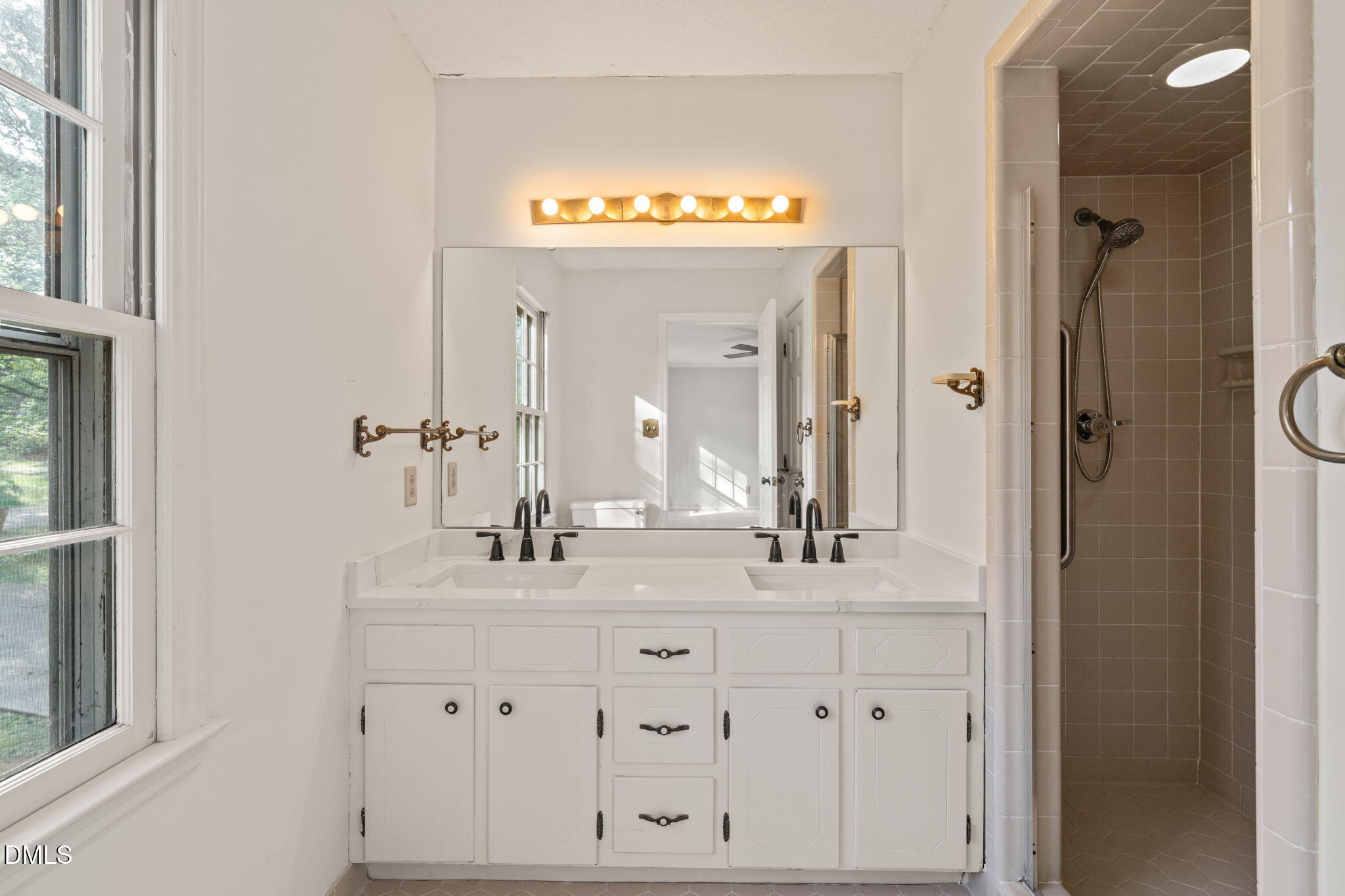6115 Winthrop Drive Raleigh, NC 27612 - Photo 28 of 41 a bathroom with a sink vanity and a mirror