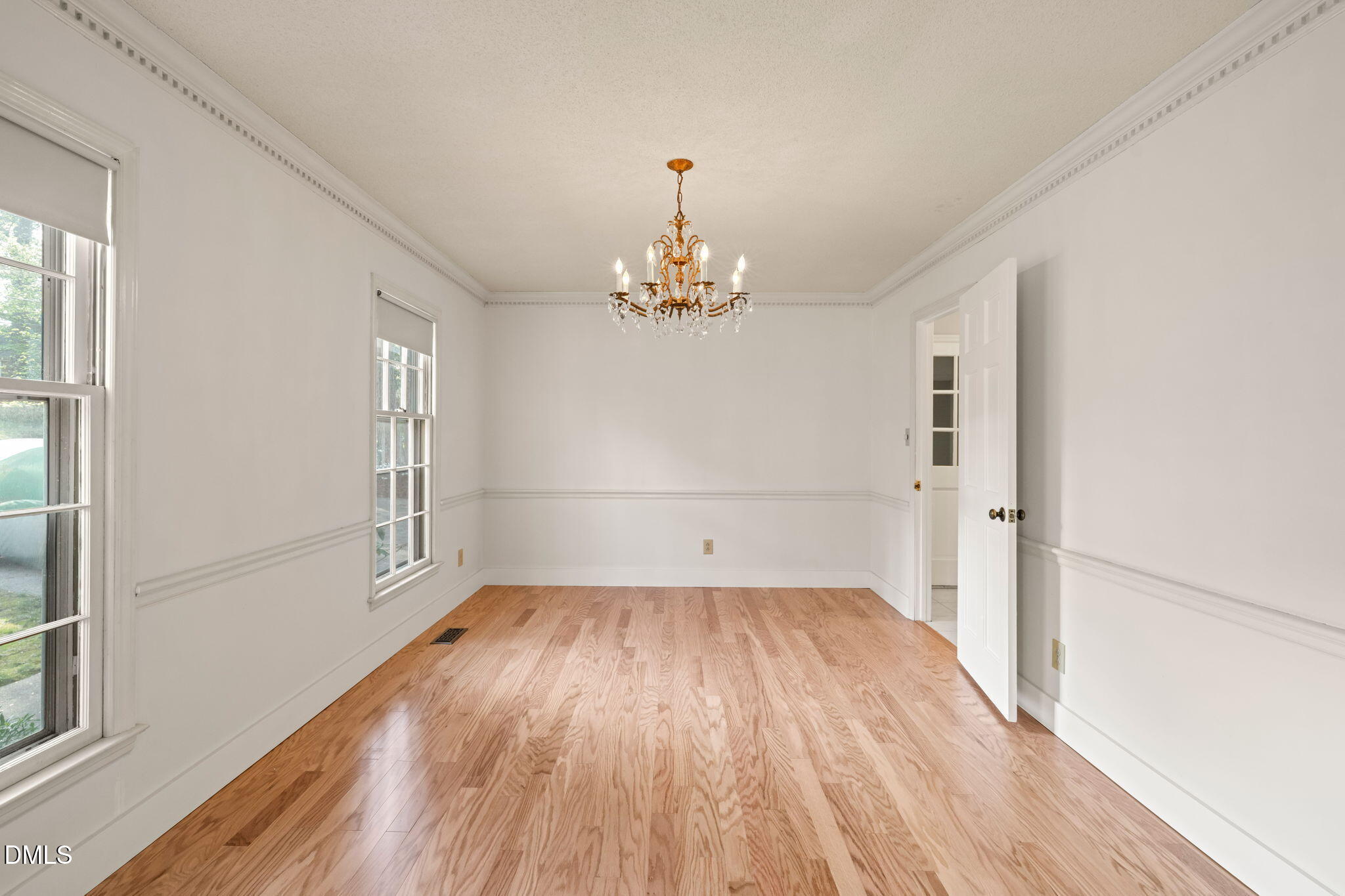 6115 Winthrop Drive Raleigh, NC 27612 - Photo 5 of 41 wooden floor in an empty room with a window