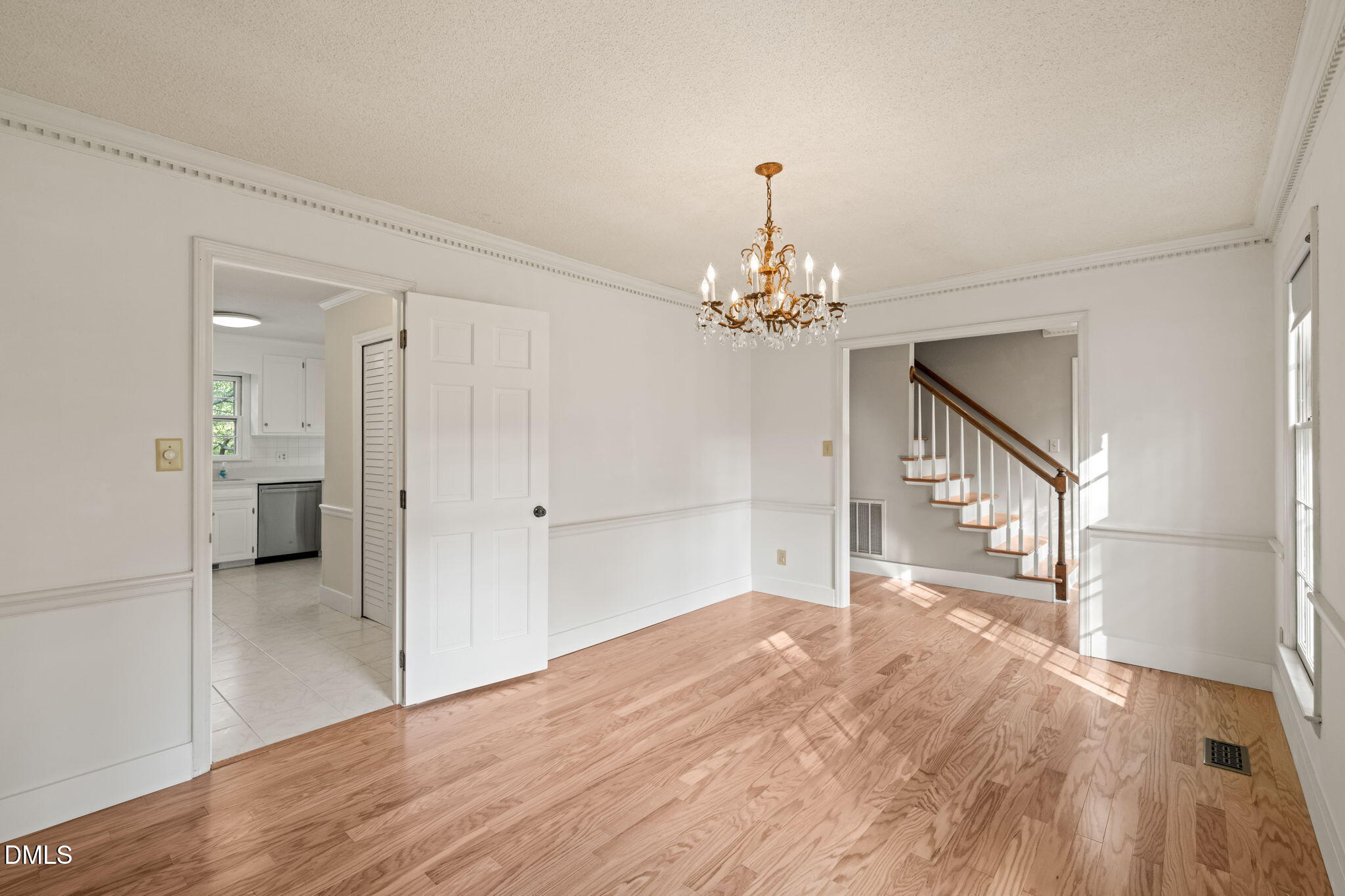 6115 Winthrop Drive Raleigh, NC 27612 - Photo 6 of 41 a view of a livingroom with wooden floor and a kitchen space