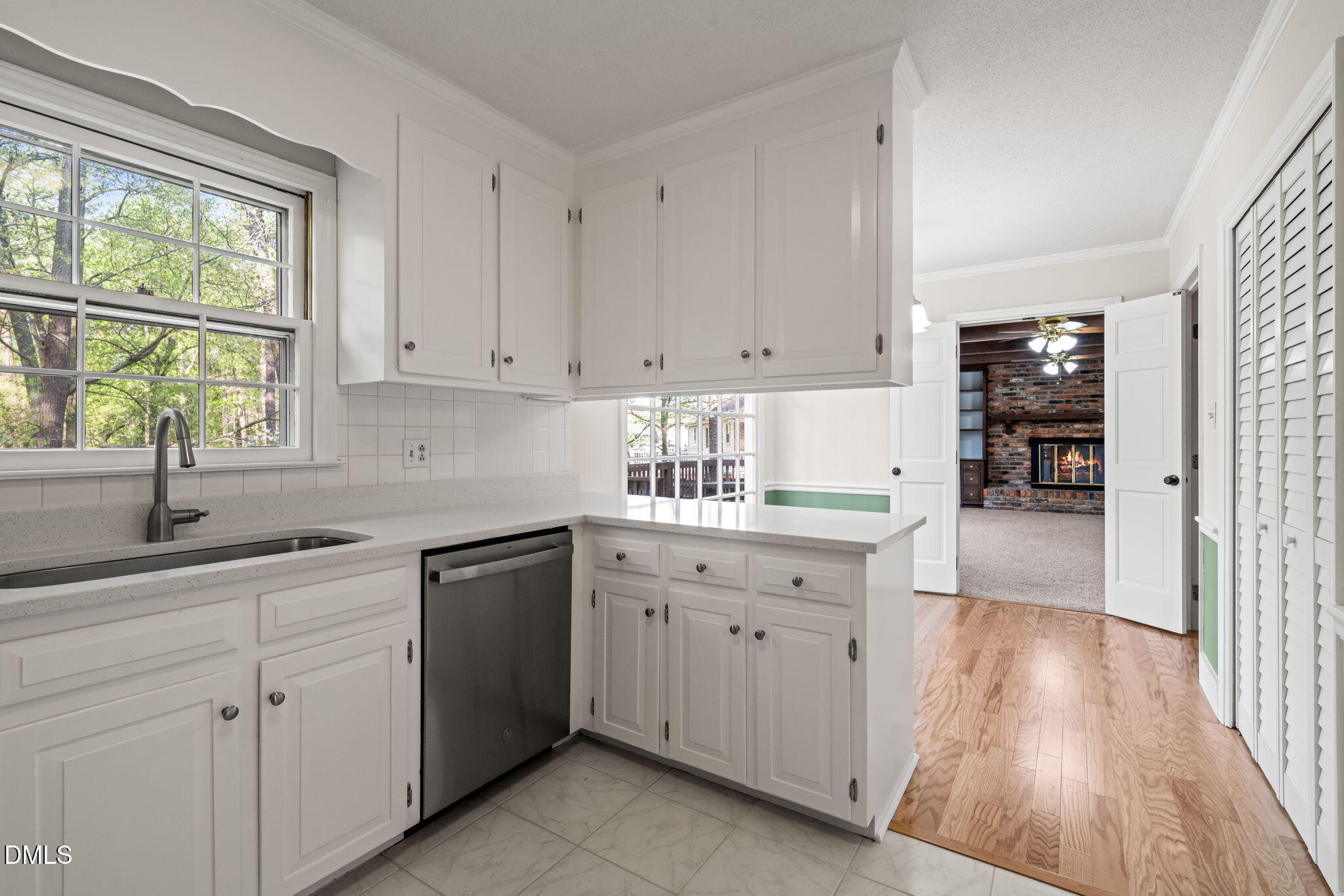 6115 Winthrop Drive Raleigh, NC 27612 - Photo 9 of 41 a kitchen with sink cabinets and window