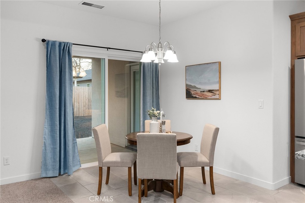 377 Bellamy Terrace Chico, CA 95973 - Photo 15 of 44 Dining area with a sliding door to the patio.
