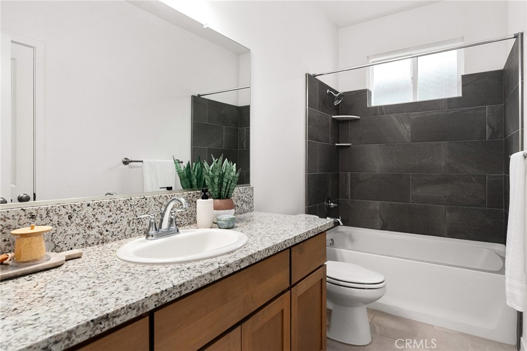 377 Bellamy Terrace Chico, CA 95973 - Photo 25 of 44 Guest bathroom with shower/tub combo and tile surround