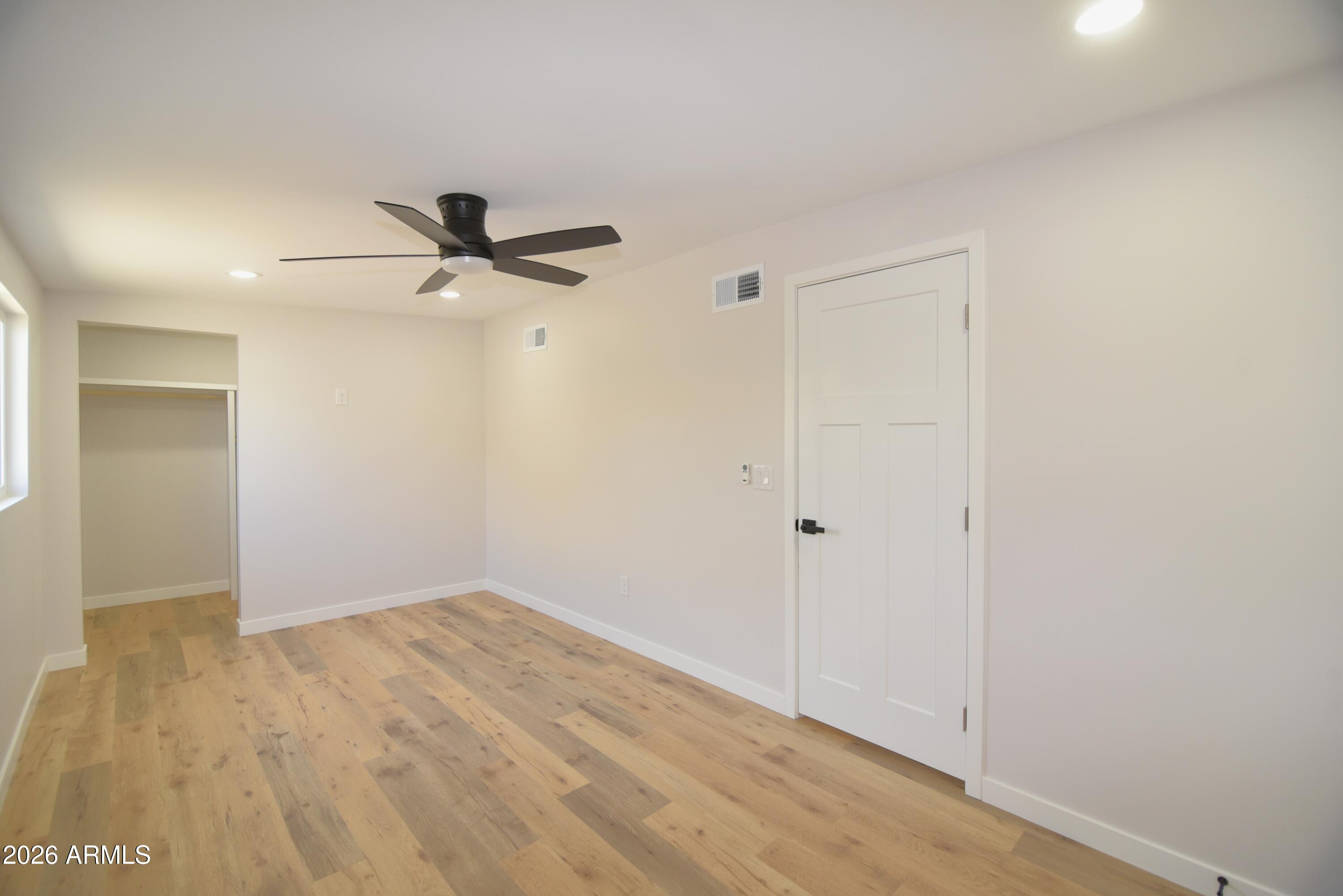 508 South 98th Street Mesa, AZ 85208 - Photo 11 of 34 a view of a room with wooden floor and a ceiling fan