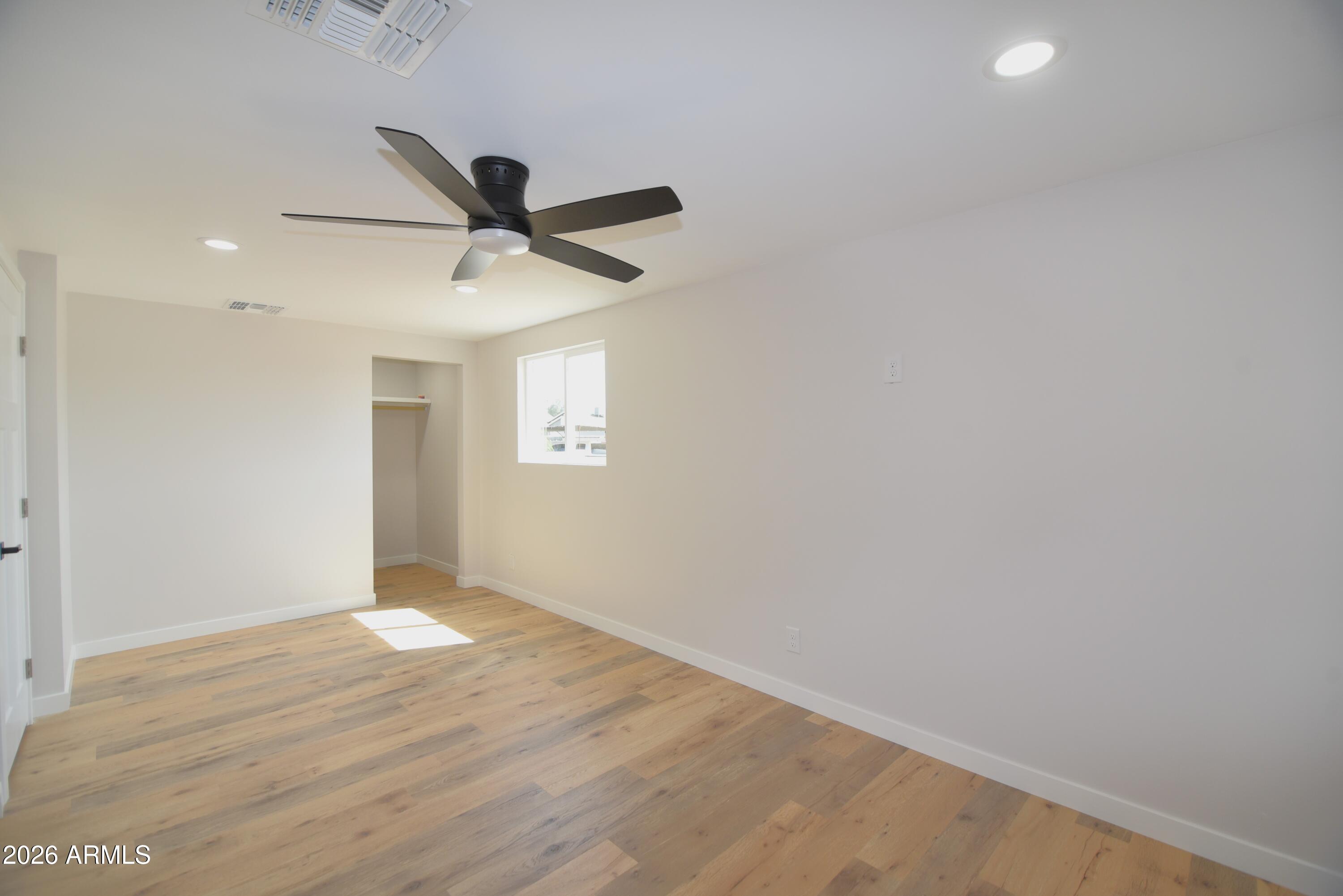 508 South 98th Street Mesa, AZ 85208 - Photo 15 of 34 an empty room with a window and a fan