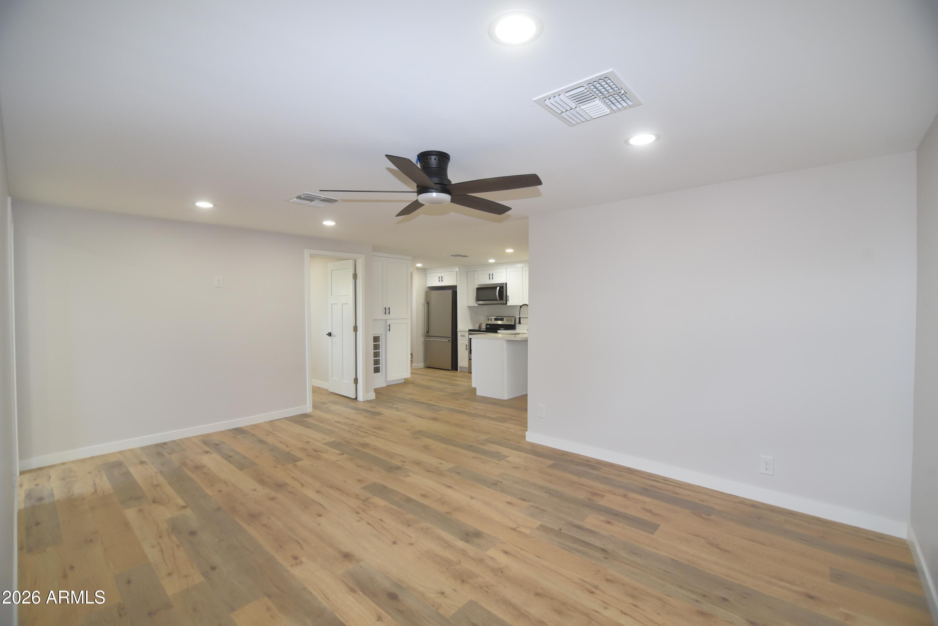 508 South 98th Street Mesa, AZ 85208 - Photo 2 of 34 a view of empty room with wooden floor and ceiling fan