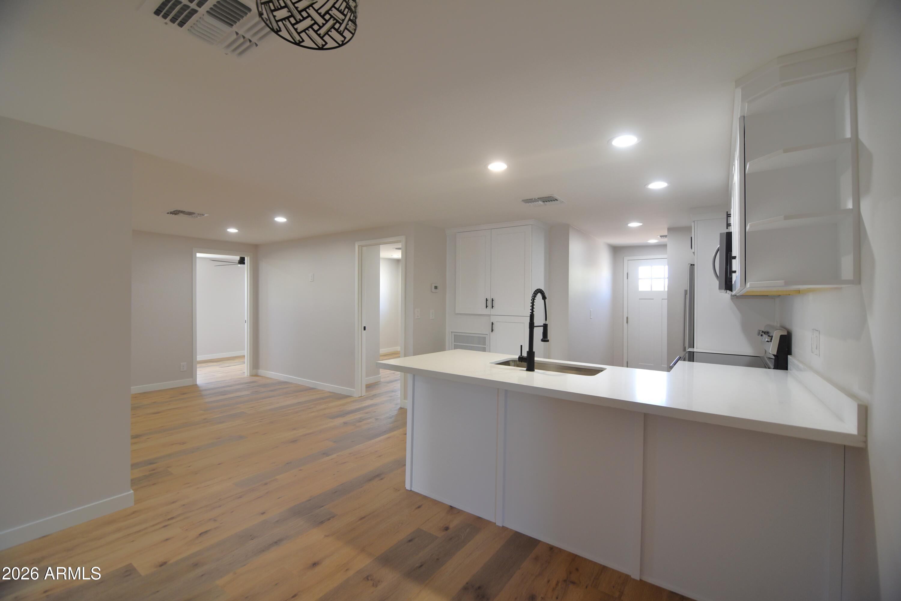 508 South 98th Street Mesa, AZ 85208 - Photo 9 of 34 a large kitchen with kitchen island a sink stainless steel appliances and a counter top