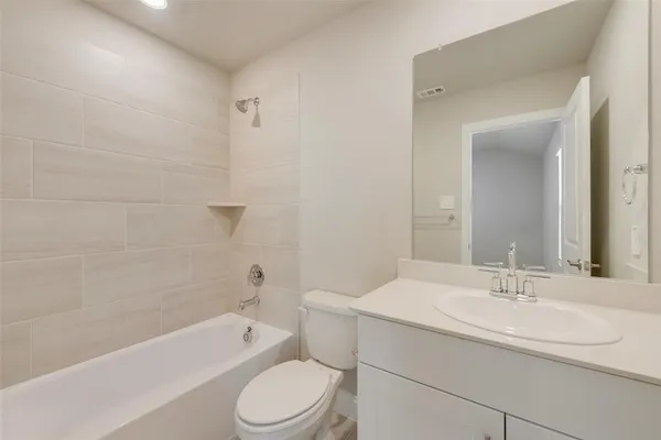 a bathroom with a sink a toilet and bathtub