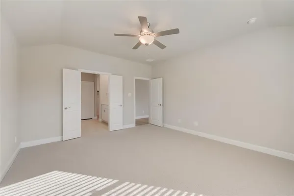 a view of an empty room with a ceiling fan