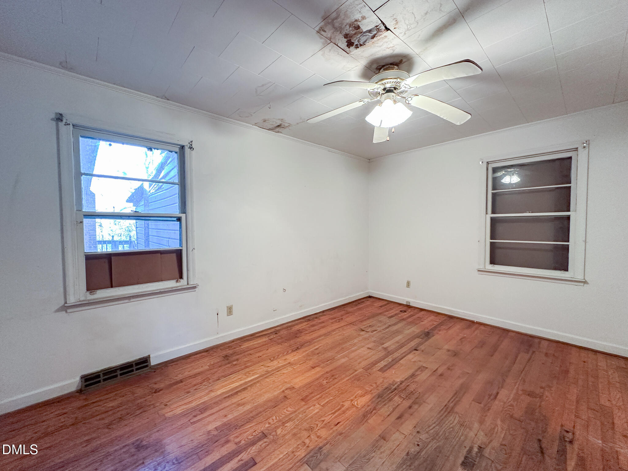 188 Jones Chapel Road Norlina, NC 27563 - Photo 27 of 71 an empty room with wooden floor chandelier fan and windows