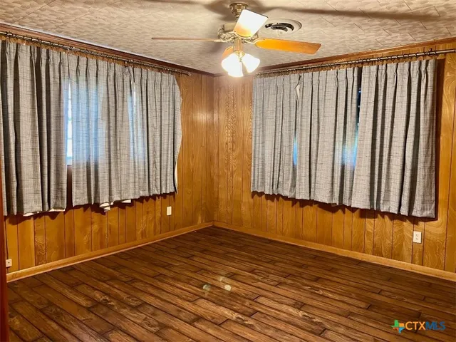 a view of a room with wooden floor