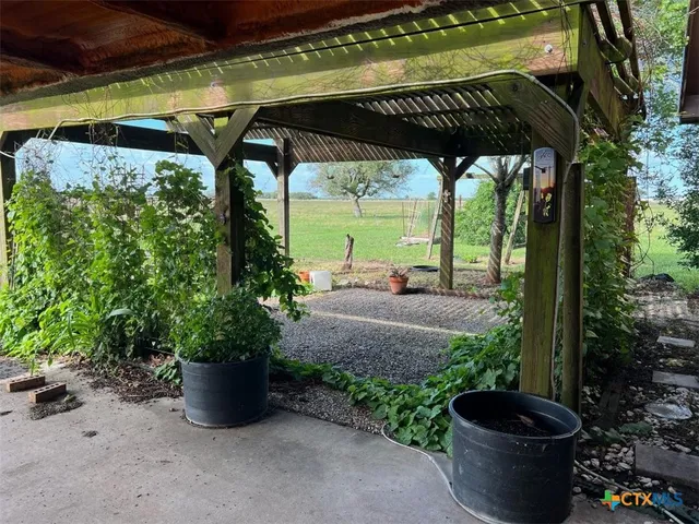 a view of a back yard with green space and seating