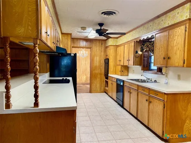 a kitchen with stainless steel appliances a sink and a refrigerator