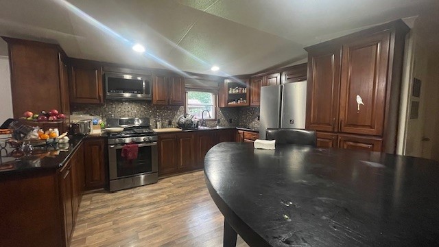 29719 Midland Street Magnolia, TX 77354 - Photo 11 of 21 a kitchen with stainless steel appliances granite countertop a sink a stove and a refrigerator