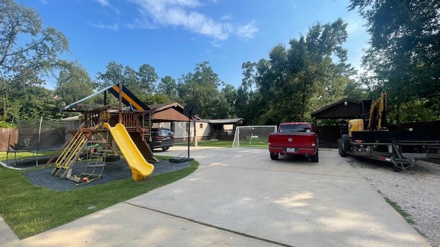 29719 Midland Street Magnolia, TX 77354 - Photo 5 of 21 a view of a house with a car park