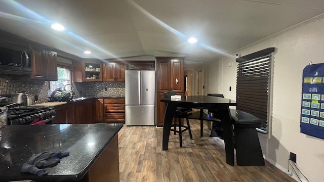 29719 Midland Street Magnolia, TX 77354 - Photo 10 of 21 a kitchen with stainless steel appliances a dining table chairs stove refrigerator and cabinets